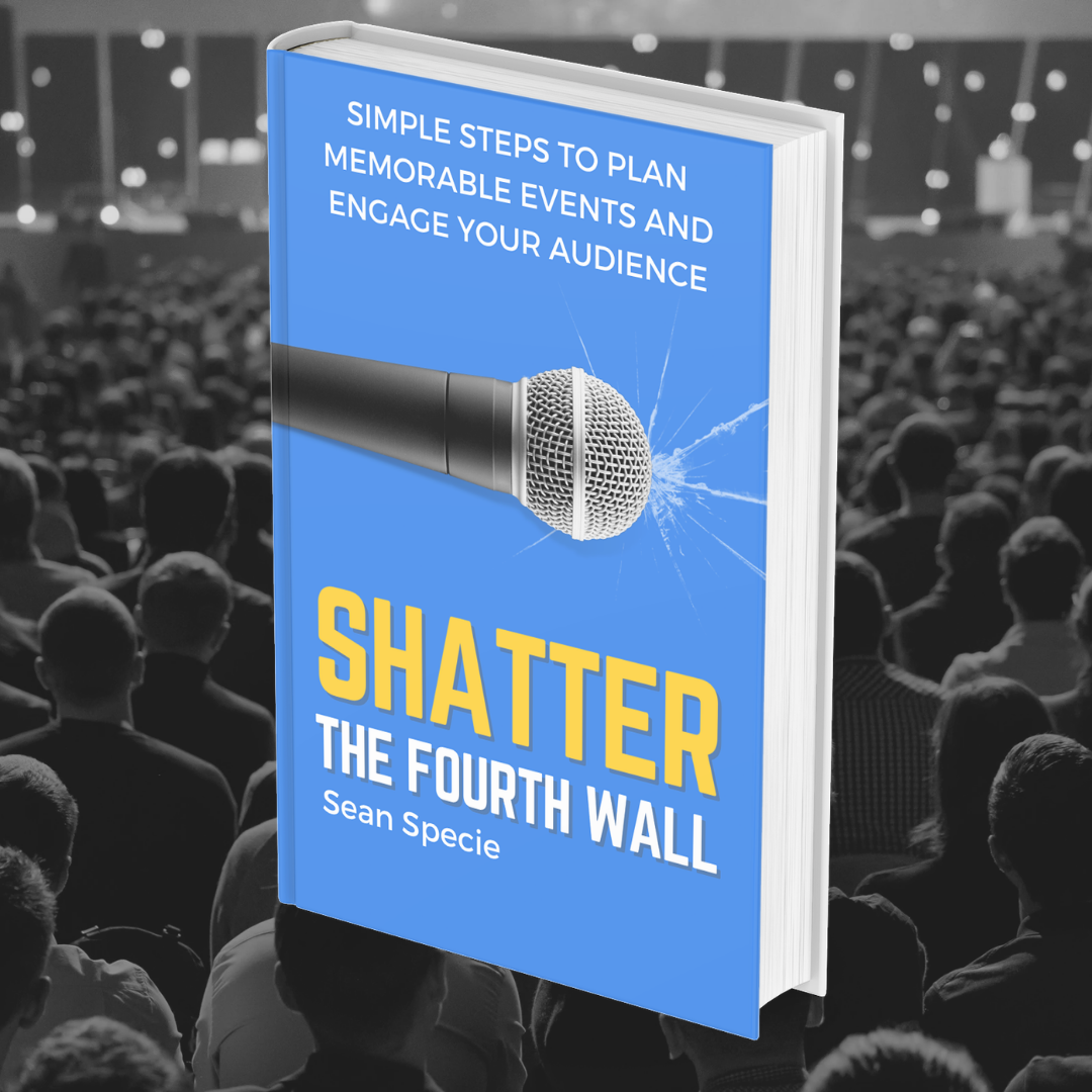 Shatter the Fourth Wall held up in front of a full auditorium