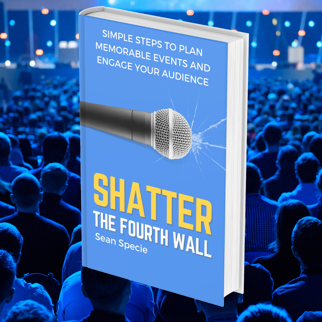 Shatter the Fourth Wall held up in front of a full auditorium